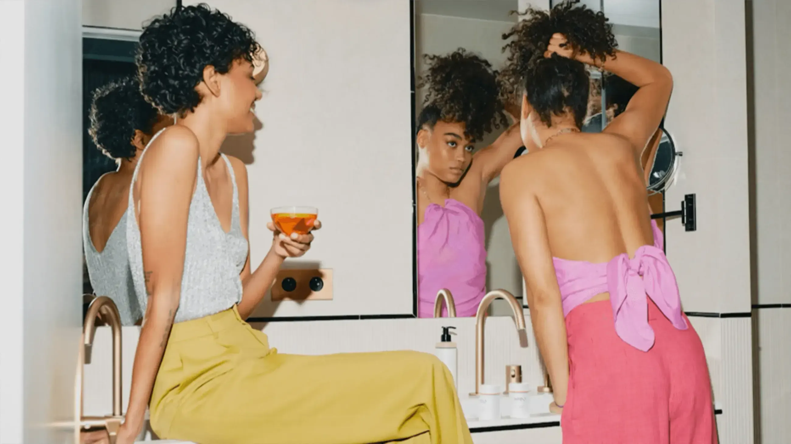 Friends getting ready together, tea in hand